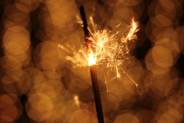 Bengal fire and sparks macro photo festive bokeh background Christmas and New Year