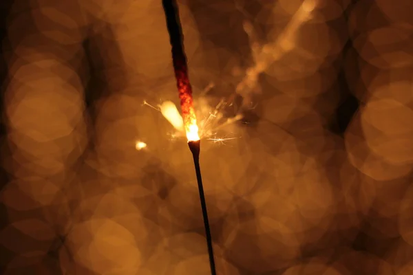 Bengal fire and sparks macro photo festive bokeh background Christmas and New Year