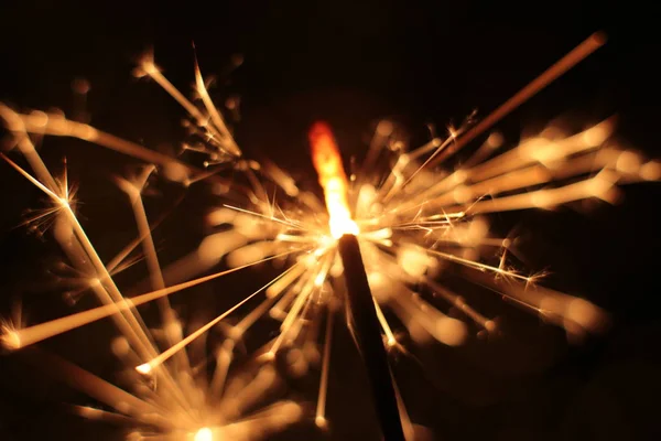 Bengal fire and sparks macro photo festive bokeh background Christmas and New Year