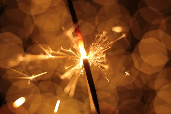 Bengal fire and sparks macro photo festive bokeh background Christmas and New Year