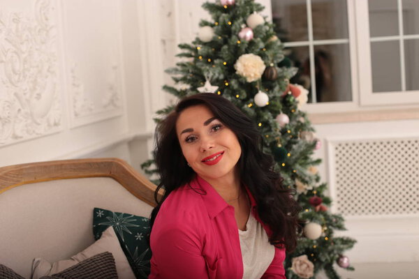 playful young woman celebrates christmas