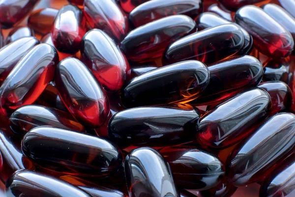 macro background burgundy smooth pills, medical bio supplements and vitamins good for health