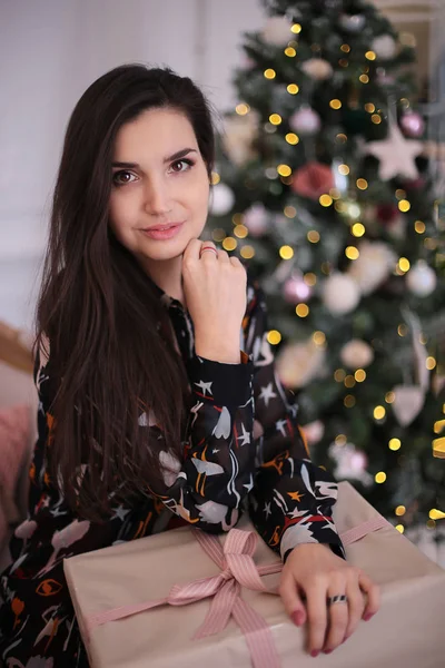 Christmas beauty smiling girl with long black hair in a good mood