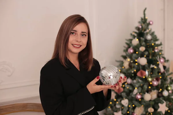 Christmas beauty smiling girl with long black hair in a good mood