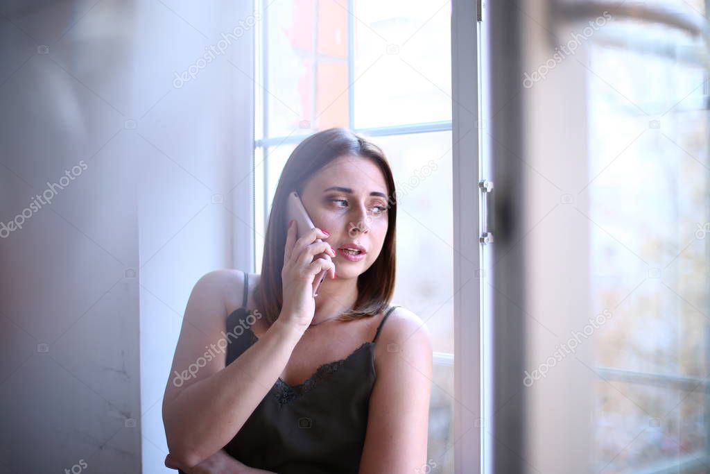 Pensive girl by the window