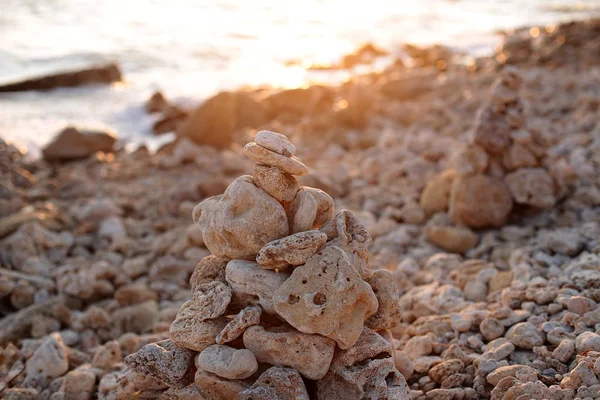 balance of stones at sunset by the sea the beauty of the nature of dawn