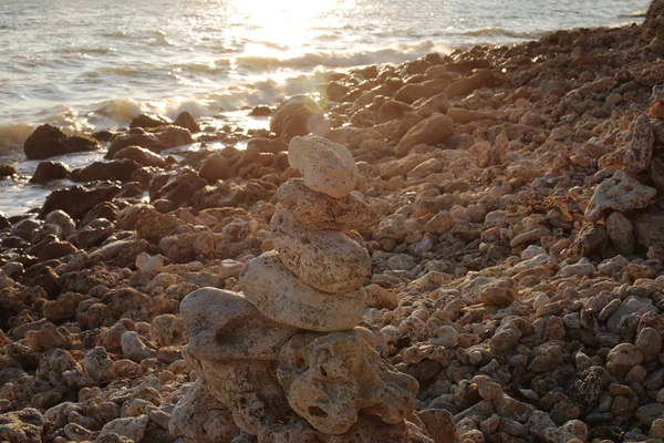 balance of stones at sunset by the sea the beauty of the nature of dawn