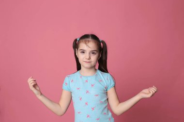 happy smiling girl with two tails long hair in a great cheerful mood on a bright pink background