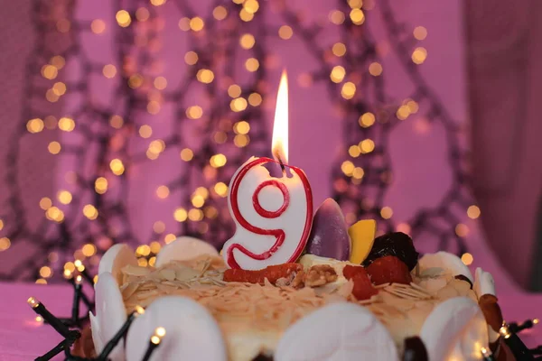 Burning candle in the cake