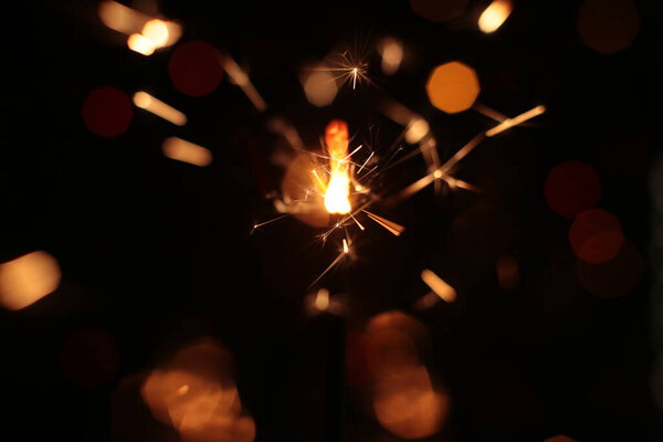 Festive burning sparkler macro photo