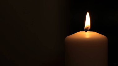 Mourning candle of sadness and longing. Festive fire macro background. clipart