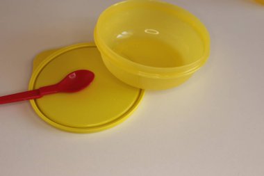 Beyaz masa arkasında boş plastik yemek takımı