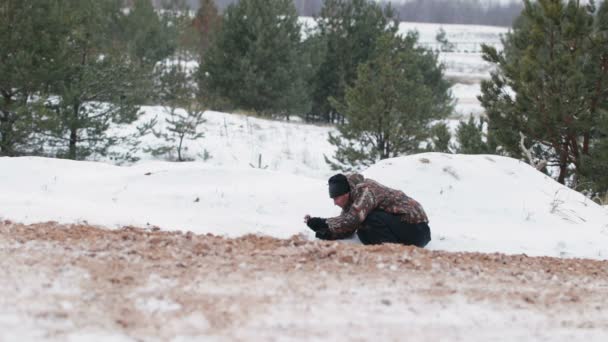 The guy is riding an ATV on a snow-covered road in winter — Stock Video