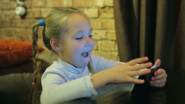 Niña feliz con teléfono inteligente en la cafetería — Vídeos de Stock