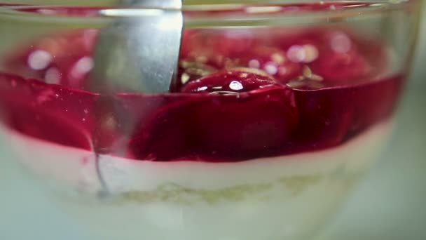Vrouw lepel van consumptie-ijs met kersen eten in een glas — Stockvideo