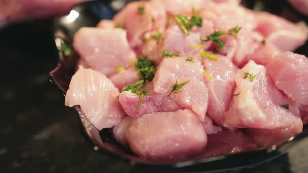 Frozen seasoning is poured into pieces of fresh meat, close-up — Stock Video