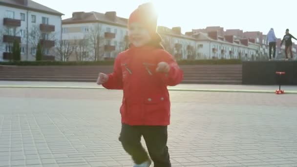 Menino alegre montando uma scooter — Vídeo de Stock