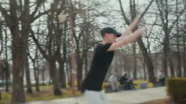 Trendy young man doing break dance in the street — Stock Video