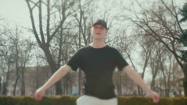 Trendy young man doing break dance in the street — Stock Video