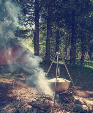 Gıda açık bir yangın bir orman kampında bir İbriği pişirilir 