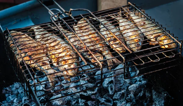 Fish fried on a grill outdoors — Stock Photo, Image