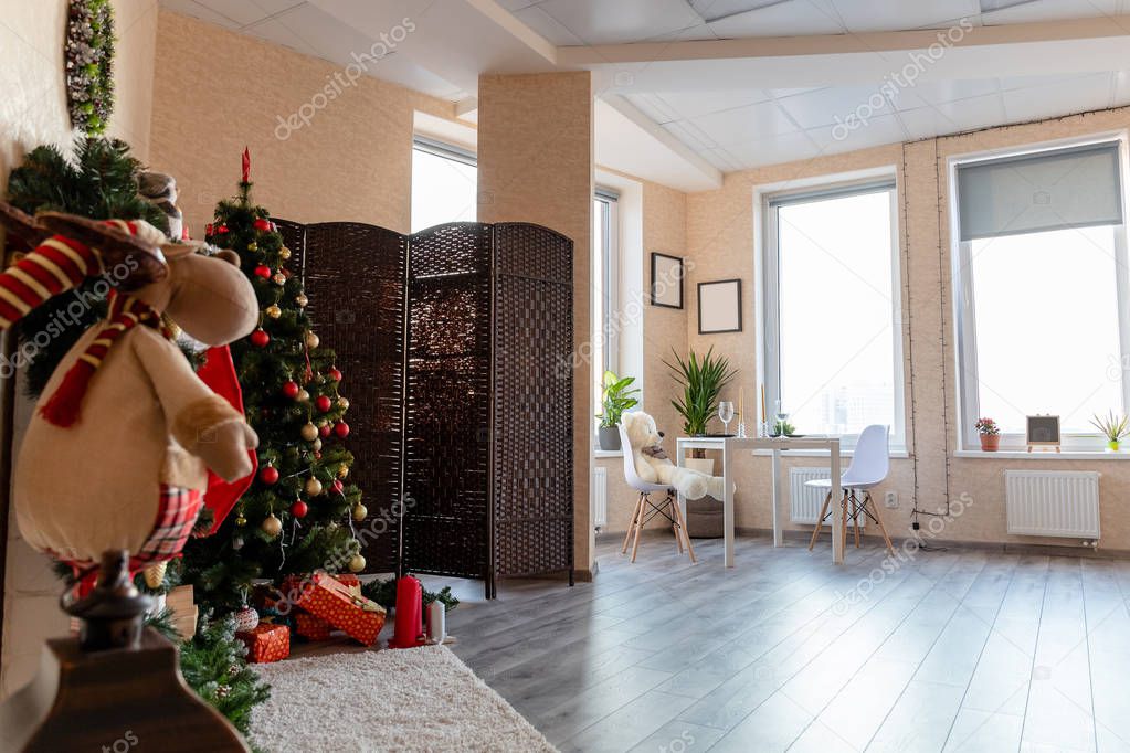 bright room with christmas tree and large windows