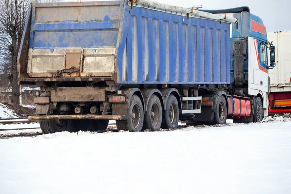 big truck with a trailer in the snow