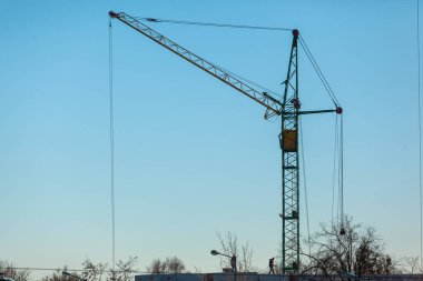 Mavi gökyüzüne karşı inşaat vinci