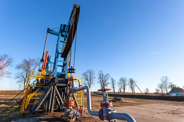 close-up of a sunlit oil extracting tower during operation