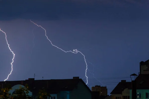 bright flashes of lightning in the night sky over the city