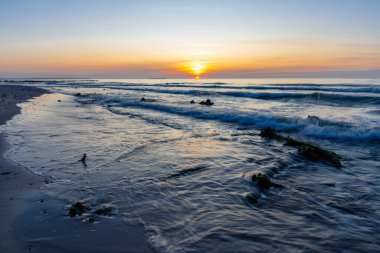 beautiful natural scene, sunset by the sea and long exposure waves