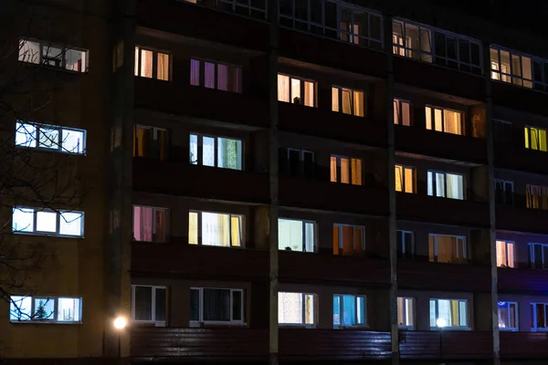 light in the windows at night in an apartment building