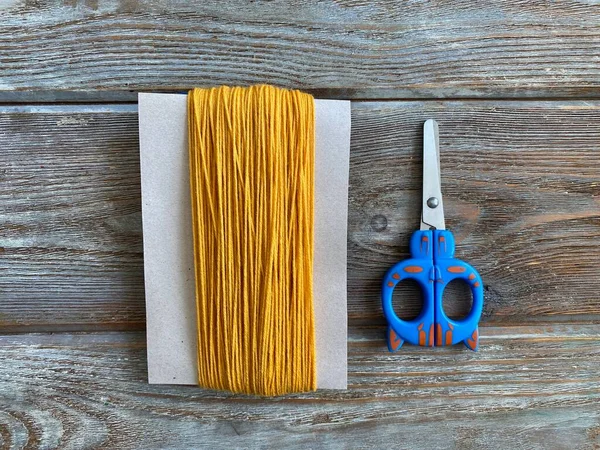 La borla de hilo amarillo, un tutorial sobre cómo hacer un monstruo, una artesanía de los niños . —  Fotos de Stock