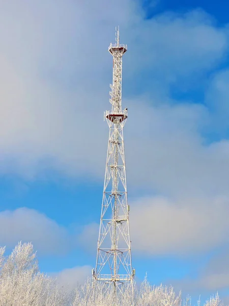 Cell antenna, transmitter. Telecom TV radio mobile tower against blue sky