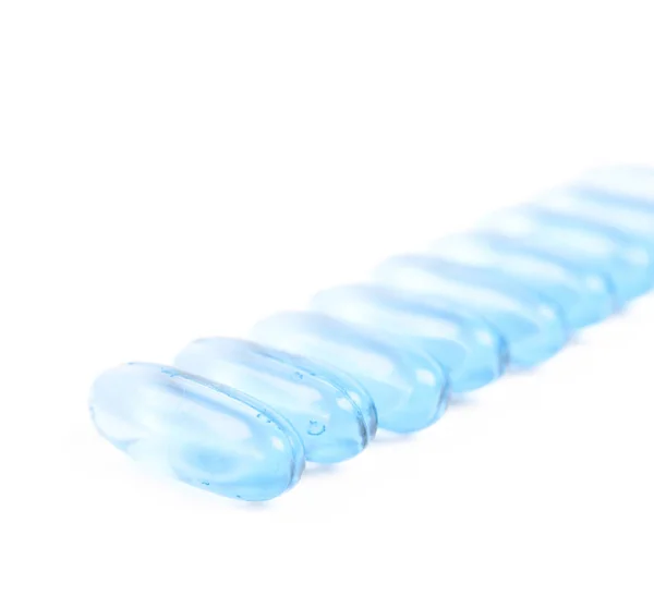 Line of multiple softgel pills isolated — Stock Photo, Image