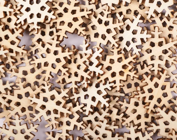 Surface covered with wooden snowflakes — Stock Photo, Image