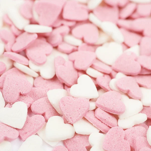 Surface coated with heart shaped sprinkles — Stock Photo, Image