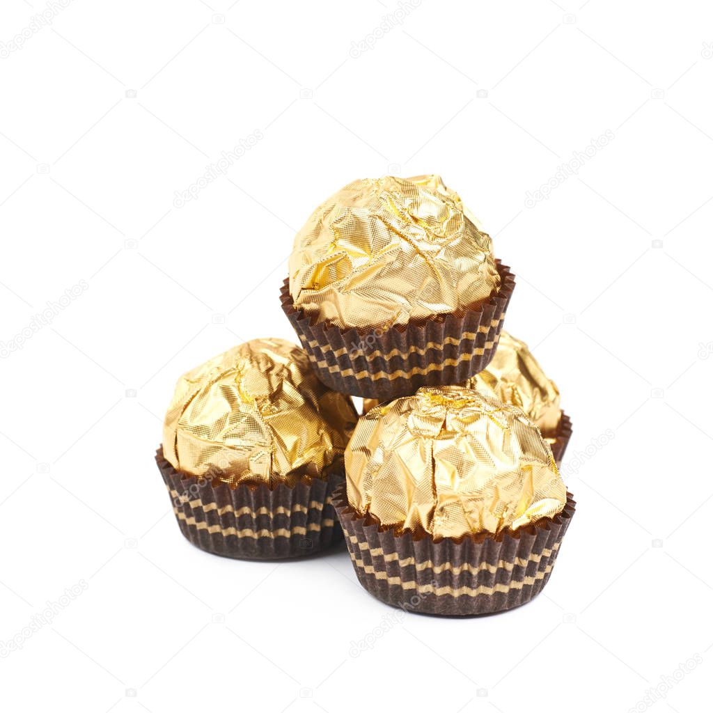 Pile of golden confection candies isolated