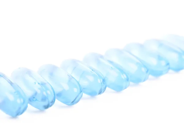 Line of multiple softgel pills isolated — Stock Photo, Image