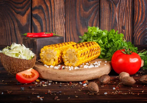 Grilled corn with spices, herbs and tomatoes