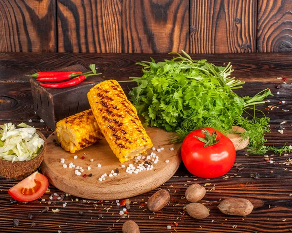 Grilled corn with spices, herbs and tomatoes