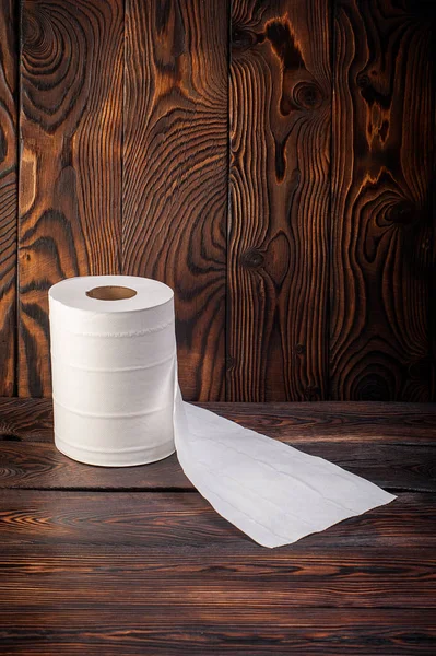 Toilet paper on wooden background Royalty Free Stock Photos