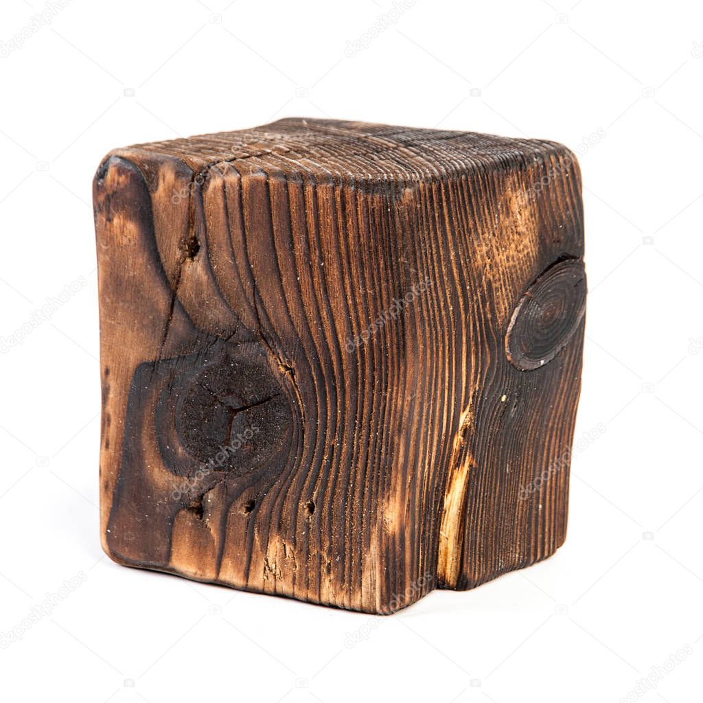 Big old dark cube is cut out from old wood. Isolated on white