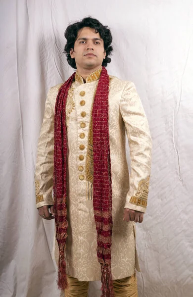 indian model wearing cream sherwani