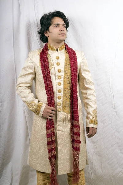 young indian male model wearing cream sherwani