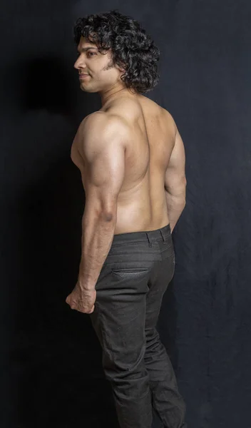 young indian male body builder posing back