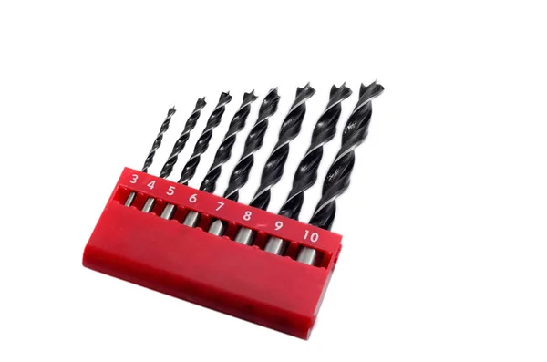 Set drill bits in box in white isolated background. Stock Photo