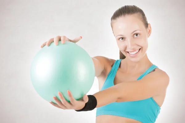 Fit Woman Standing Holding a Pilates Ball Fotografie de stoc