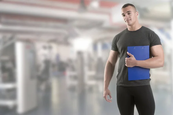 Personal Trainer, with a pad in his hand — Stock Photo, Image