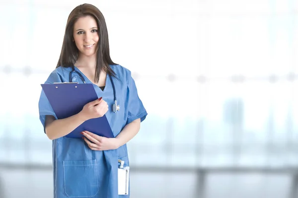 Young female doctor with a pad  and a stethoscope — Stock Photo, Image